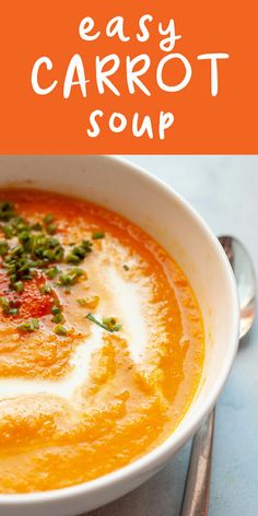 a white bowl filled with carrot soup on top of a table