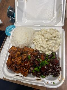 a plastic container filled with rice, meat and veggies