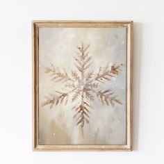 a painting of a snowflake is hanging on the wall in front of a white wall