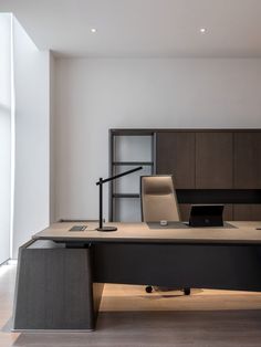 an office desk with a laptop on it