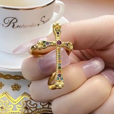 VAIGE Gold Cross Ring Colorful Cross Victorian Vintage 925 Sterling Discover the enchanting elegance of the VAIGE Gold Cross Ring, a masterpiece that beautifully combines vintage charm with modern sophistication. This exquisite ring features: Stunning Craftsmanship: Weighing 4.41g, this ring is meticulously crafted with high-quality materials, ensuring a luxurious feel and lasting durability. Vibrant Main Stone: Adorned with a captivating Zircon, the ring sparkles brilliantly, drawing attention Ancient Gold Ring, Gold Cross Ring, Victorian Vintage, Sparkling Rings, Victorian Rings, Gold Pearl Earrings, Cross Ring, Diamonds And Gold, Gold Branding