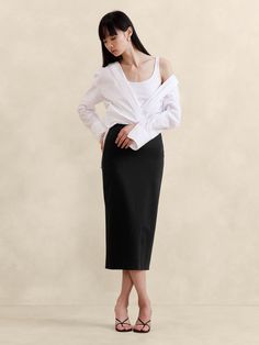 This classic pencil skirt is cut from our signature Stretch-Ponte fabric, engineered with special stretch fibers for a smooth and supportive fit.  Pencil fit.  Elastic waistband - pull-on styling.  Center back vent.  Unlined.  Pencil skirt.  Below-knee length.  Model: Size 2, 5'10" (178cm). Banana Republic Skirt, Maxi Styles, Viscose Rayon, Black Midi Skirt, Women's Skirts, Style Mistakes, 2000s Fashion, Bottom Clothes, Women Skirts Midi