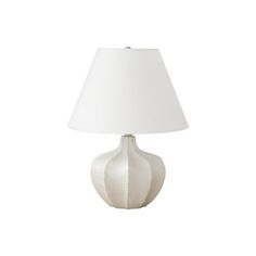 a white table lamp with a white shade on the base and a light bulb attached to it