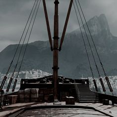 the bow of a ship with mountains in the background