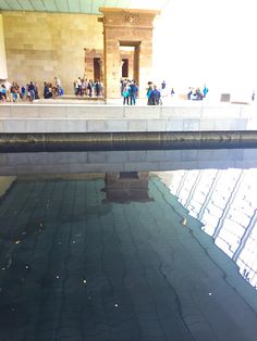 the reflection of people standing in front of a building