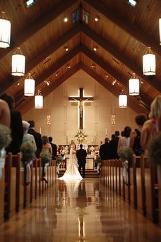 a bride and groom are walking down the aisle