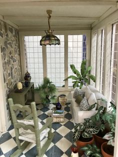 a living room filled with furniture and lots of plants