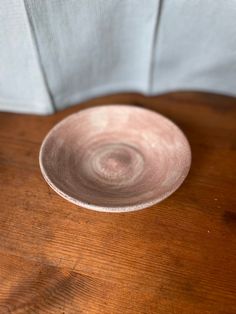 a white bowl sitting on top of a wooden table