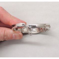 This is part of Chairish’s Costume Jewelry assortment.  1950s rhodium plated baguette and round clear rhinestone hinged cuff bracelet with security chain. Marked "Ledo" in script. Measures: 5/8 inches tall by 2 1/4 inches deep by 2 3/8 inches wide. Interior circumference is 6 1/4 inches without the hinges pulled out at all and can expand to about 7 inches. Excellent condition. Clear Rhinestones, Vintage 1950s, Rhodium Plated, Costume Jewelry, Hinges, Cuff Bracelet, Plating, Cuff, Bracelet