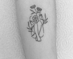 a woman's arm with flowers and the words i love you are here on it