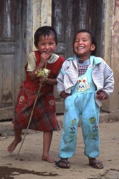 two young children standing next to each other