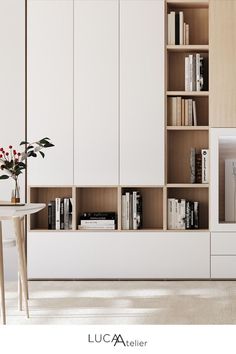 a living room filled with furniture and bookshelves next to a white dining table