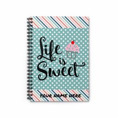 a spiral notebook with the words life is sweet on it and a cupcake design