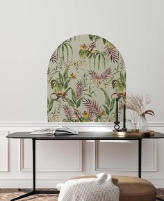 a living room with a table, chair and wallpaper