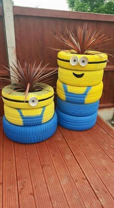 two yellow and blue tires sitting on top of a wooden deck next to each other