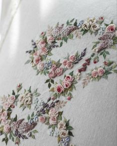 an embroidered piece of cloth with flowers on it