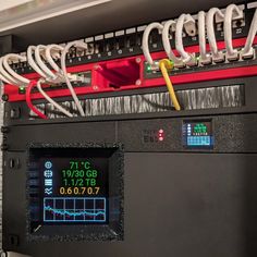 a machine that has some wires attached to it's back end and is displaying the time