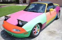 a colorful car parked in front of a house