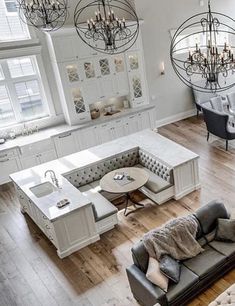 an overhead view of a living room with couches, chairs and chandeliers