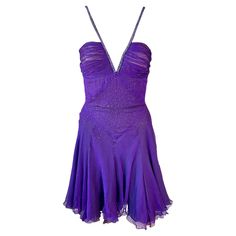 Versace c.2007 Crystal Embellished Plunging Neckline Semi-Sheer Purple Dress IT 42 Versace purple semi sheer dress featuring a plunging neckline, semi-exposed back, flared design, crystal embellished straps and rhinestones throughout the dress. Condition: small snag and discoloration near the hem. Not noticeable when worn since it disappears into the ruffled skirt. Please refer to the last photo. FOLLOW US ON INSTAGRAM @OPULENTADDICT Vintage Versace, Dior Haute Couture, Ruffled Skirt, Dress Images, Gianni Versace, Emilio Pucci, Sheer Dress, Dress C, New Wardrobe