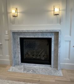 an empty fireplace in a room with white walls