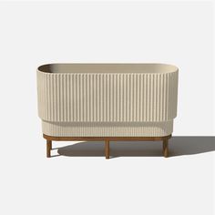 Create elevated looks this season with the Raised Demi Long planter. Inspired by Roman columns, its softened lines and fluted details add a subtle hint of texture to the patio, balcony or porch. Crafted in Canada from a patented plastic-stone composite, the Demi not only adds a subtle hint of texture but is also made to withstand harsh weather conditions ranging from -20 to +120 degrees. Its lightweight yet durable qualities are mirrored in the acacia wood stand, with sturdy structure and resist Planter Divider, Long Planter, Roman Columns, Stone Planters, Patio Balcony, Structure And Function, Outdoor Planters, Wood Stand, Acacia Wood