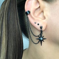 Eye catching and edgy Starburst earrings and cuff  are made of 316L Stainless steel .  Can be purchased as single or a pair. Star earrings -1 1/4 inches long Cuff is 6mm wide Short chain 1 3/4 inches MATCHING STUD IS AVAILABLE HERE: https://www.etsy.com/listing/1505099493/north-star-earring-starburst-earrings?click_key=7109df00438434e9749a84d627c791cbb97fe926%3A1505099493&click_sum=1ba011e1&ga_search_query=star&ref=shop_items_search_2&pro=1&sts=1 Star Cuff Earrings, Black Cuff Earrings, Different Star Designs, Goth Ear Piercings Grunge Jewelry, Ear Piercings Gothic, Black Star Earrings, Alternative Ear Piercings, Gothic Ear Piercings, Black Piercings Ear