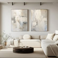 a living room with two paintings on the wall