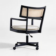 an office chair with wheels and a cushion on the back, sitting in front of a white background