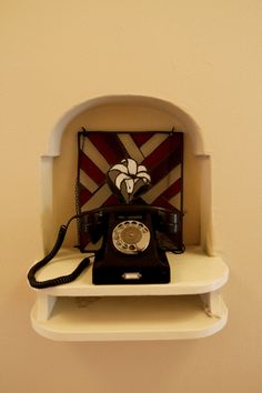 an old fashioned phone is sitting on a shelf