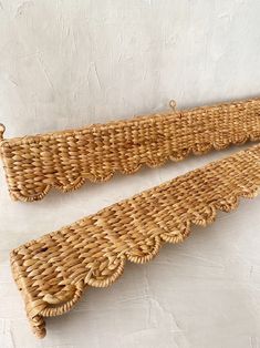 two wicker shelfs are sitting on the wall