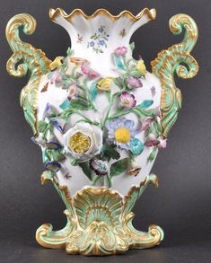 an ornate vase with flowers painted on it