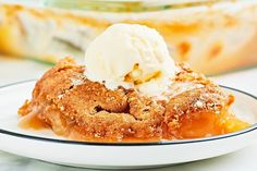 a piece of apple pie with ice cream on top is sitting on a white plate