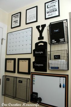 a wall with many framed pictures and other items hanging on it's side, including a letter y