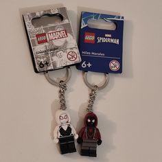 two lego keychains that have been placed next to each other