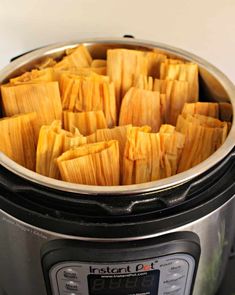 an instant pot roaster filled with tamales