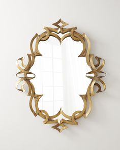 an ornate gold mirror hanging on the wall