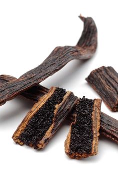 several pieces of brown dog treats on a white surface