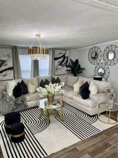 a living room filled with furniture and lots of decor on top of a wooden floor