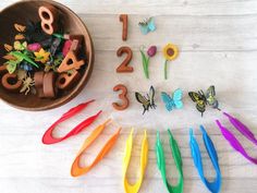 the numbers are made out of colorful plastic scissors and flowers in front of a potted plant