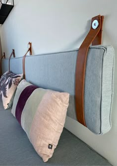 the headboard and pillows are hanging on the wall