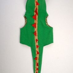 an ornament made to look like a green christmas tree with red and gold decorations