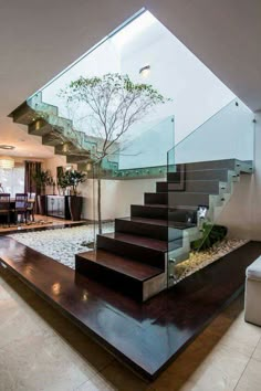 an image of a room with stairs and plants on the floor in front of it