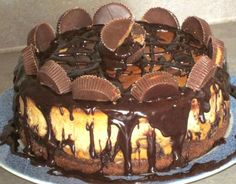 a cake with chocolate and peanut butter frosting sitting on top of a blue plate