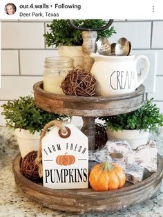 three tiered tray with pumpkins and coffee mugs