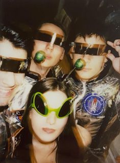 a group of young people wearing green sunglasses