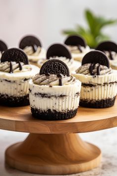 oreo cookies and cream cupcakes on a wooden cake platter, ready to be eaten