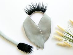 a black and white hair brush next to some fake flowers