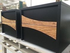 two black and wood boxes sitting on top of a table