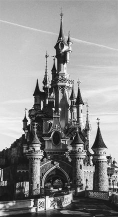 a black and white photo of a castle with turrets on it's roof,